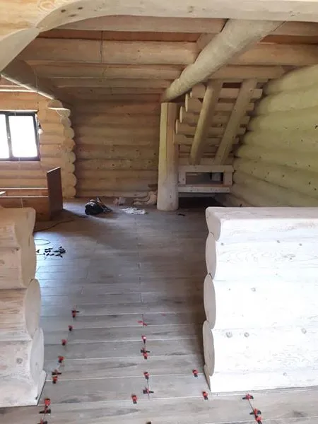 Interior cabană din lemn cu grinzi aparente